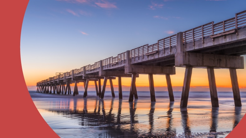 A beach view with Jacksonville Pier at dawn in Jacksonville, Florida.