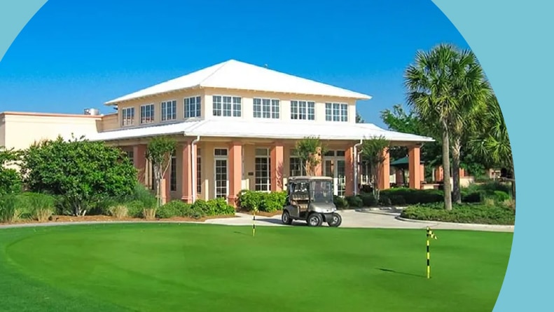 A golf cart in front of a clubhouse at On Top of the World in Ocala, Florida.