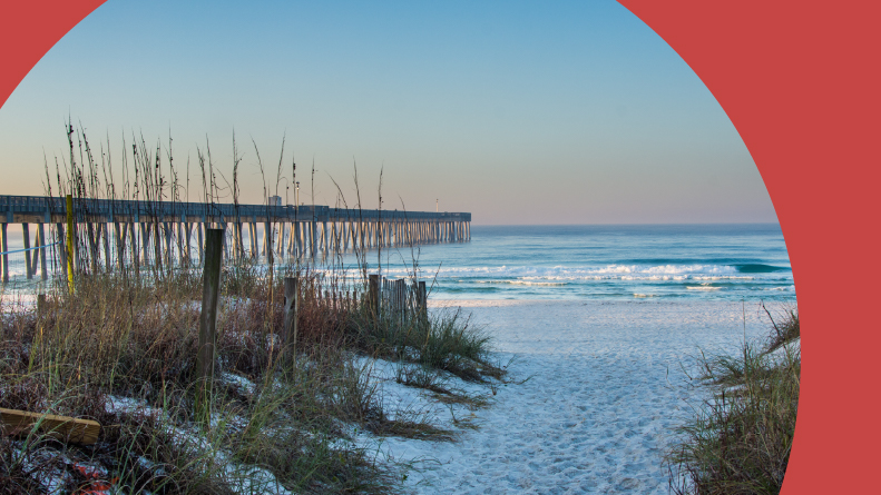 Sandy Panama City Beach Pier at sunrise in Panama City, Florida.