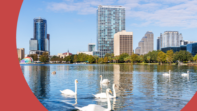 The Orlando skyline at Lake Eola Park with swans in Florida.
