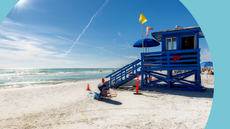 Lifeguard hut on Siesta Key Beach on a summer day beside the ocean.