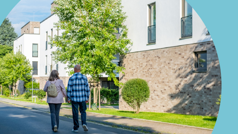 An active adult couple touring a 55+ community.