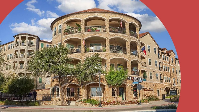 Exterior view of the residential buildings at Bell Tower Flats in McKinney, Texas.