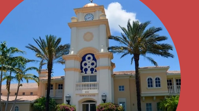 Palm trees beside the entrance to Island Walk in Naples, Florida.