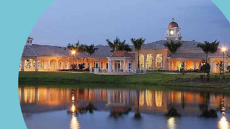 View across the pond of the clubhouse at VeronaWalk in Naples, Florida.