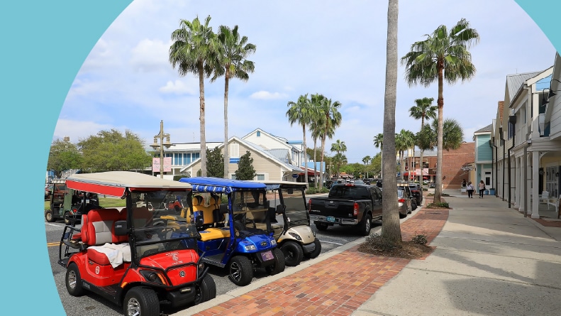 Three colorful golf carts parked in front of Shoppes in The Villages.
