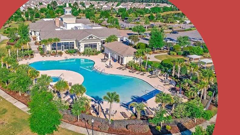 Aerial view of a clubhouse and resort-style pool at Del Webb at Cane Bay in Summerville, South Carolina.
