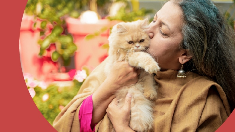 A 55+ woman holding her foster kitten.