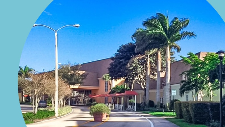 Palm trees lining the entrance road to Kings Point in Delray Beach in Delray Beach, Florida.