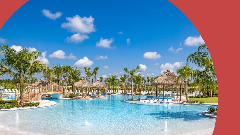 Palm trees and lounge chairs beside an outdoor, resort-style pool at Latitude Margaritaville in Daytona Beach, Florida.