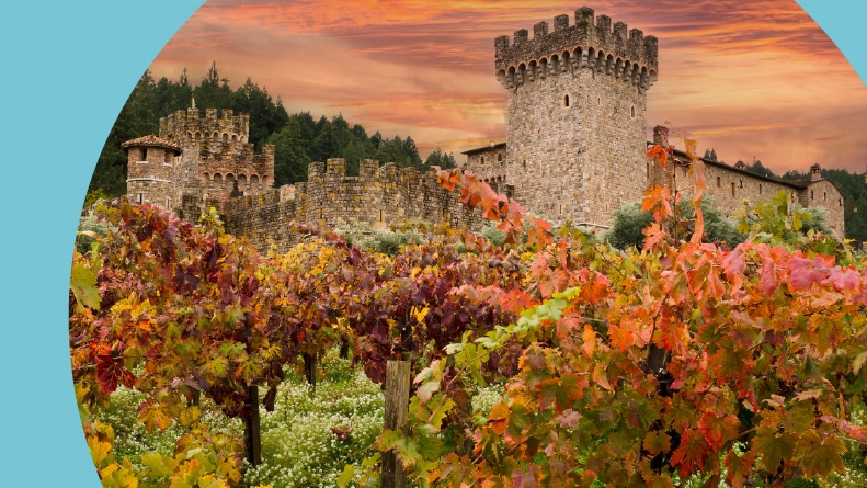 Napa Valley castle winery with vineyard grape vines in autumn colors.