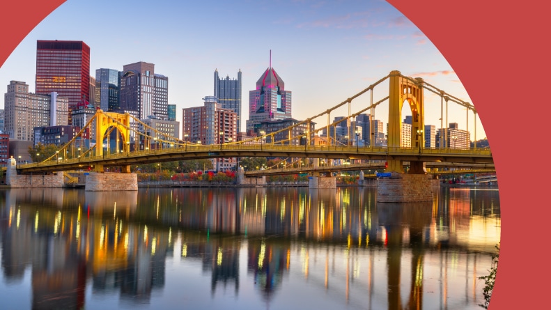 The downtown city skyline on the Ohio River at dusk in Pittsburgh, Pennsylvania.