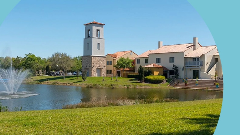 A scenic pond beside community buildings on the grounds of Solivita in Kissimmee, Florida.