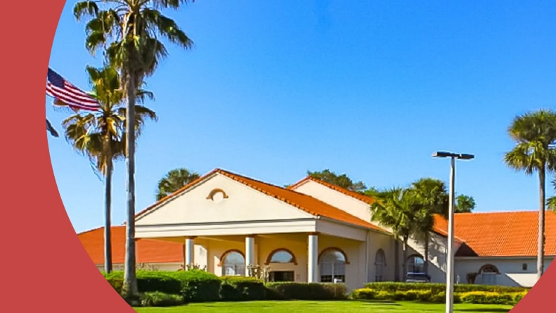 Palm trees surrounding the entrance to Spruce Creek South in Summerfield, Florida.