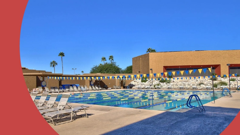 Lounge chairs beside an outdoor lap pool at Sun City in Sun City, Arizona.