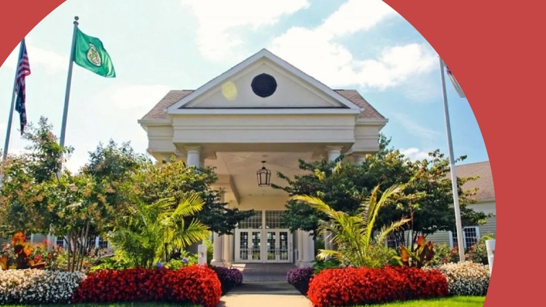 Flag poles and landscaped greenery outside the clubhouse at Westlake Golf and Country Club in West Lake Township, New jersey.