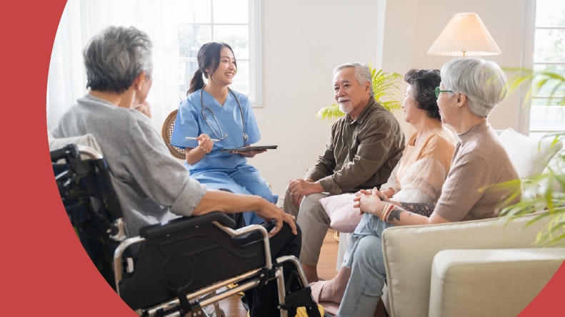 Seniors in an independent living home listening to a nurse.