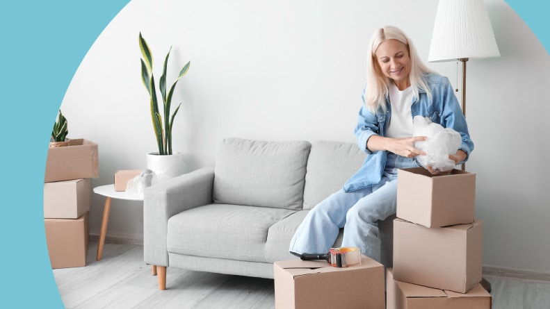 A 55+ woman packing things on moving day.