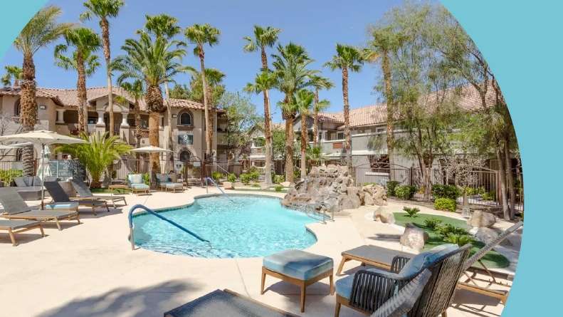 Palm trees and lounge chairs beside the outdoor pool at Destinations Pueblo in Las Vegas, Nevada.