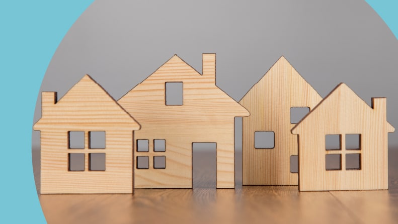 Wooden house models on a table.