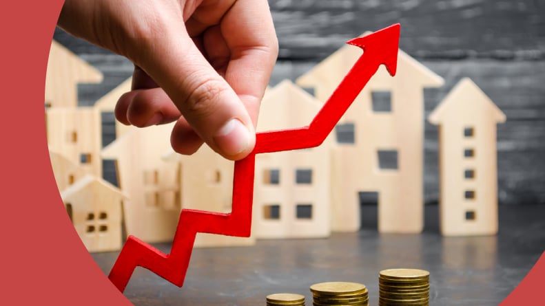 Wooden houses in a row behind a red arrow pointing up.