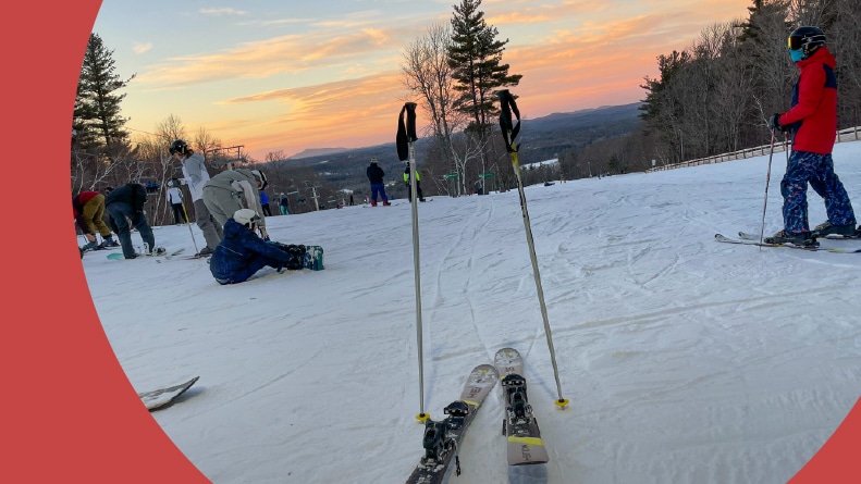 People skiing at sunset in the Boston mountains.