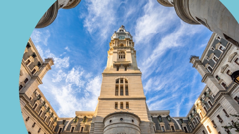 Low-angle view of the courtyard of the Philadelphia City Hall on a sunny summer day with blue sky.