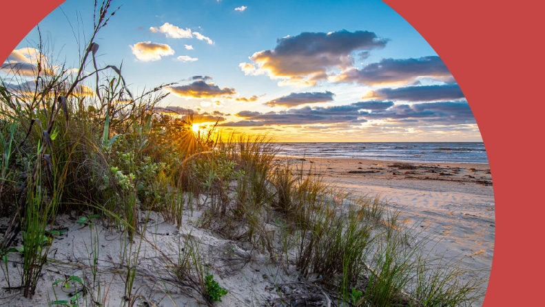Sunrise over sand dunes along the Texas coast.