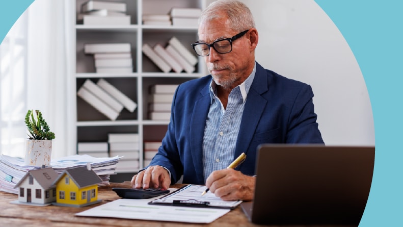 A 55+ man signing a real estate contract.