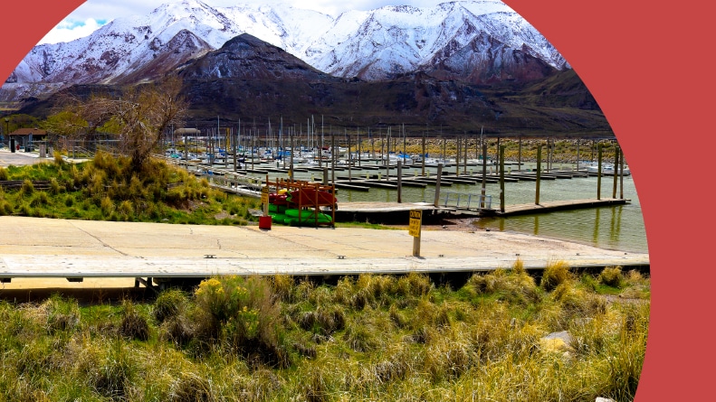 A marina and boat launch at the Great Salt Lake near the snow-capped mountains of Farnsworth Peak.