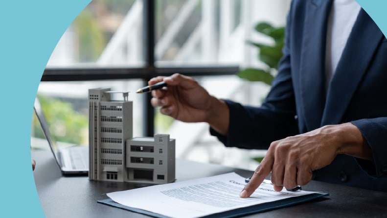 A real estate agent explains the details of a condo purchase to a 55+ homebuyer.