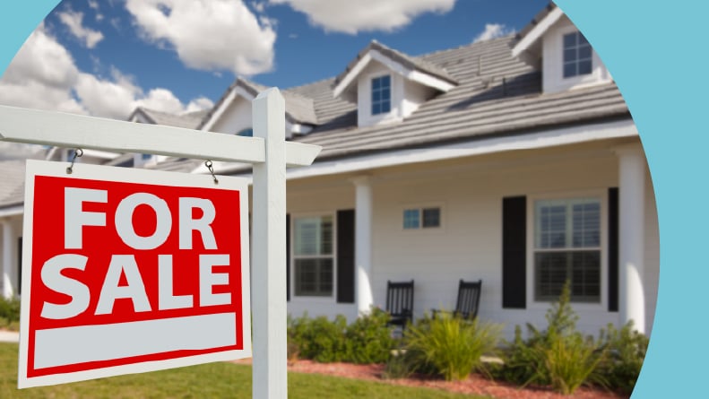 A "For Sale" sign in front of a house.