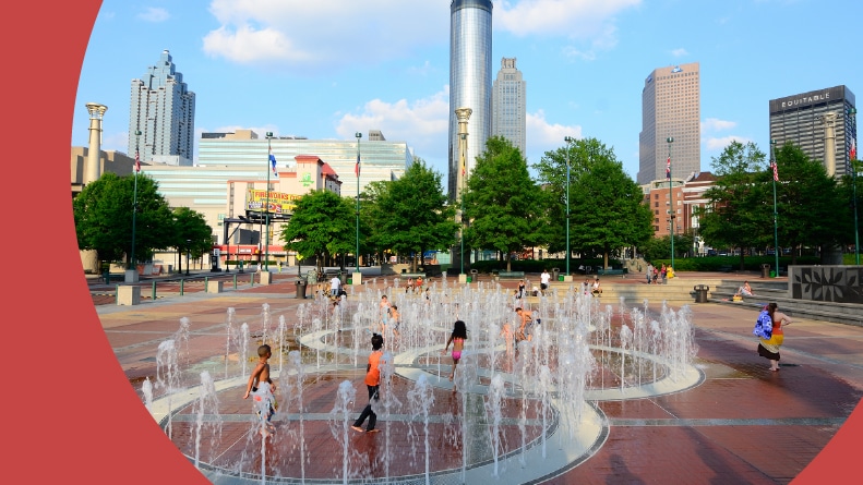Kids playing in the fountains at Centennial Olympic Park in Atlanta, Georgia on a summer day.