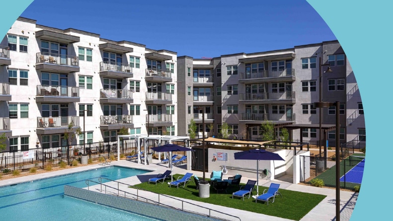 Lounge chairs beside the outdoor pool surrounded by the apartment buildings at Mera Rhodes Ranch in Las Vegas, Nevada.