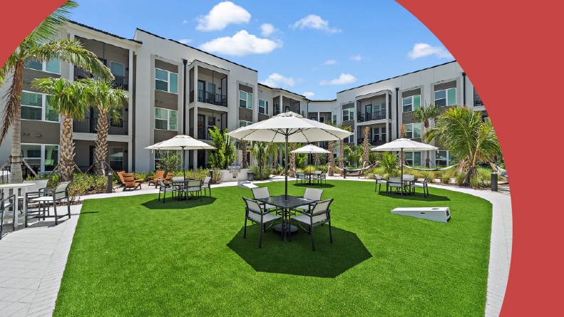 Lounge chairs and tables on the lawn at Mira at Palmer Ranch in Sarasota, Florida.