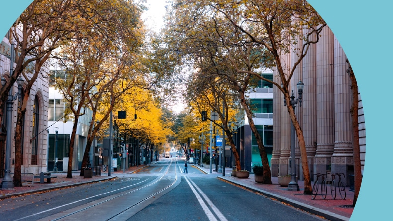 An empty street in downtown on a sunny autumn day with no cars in Portland, Oregon.