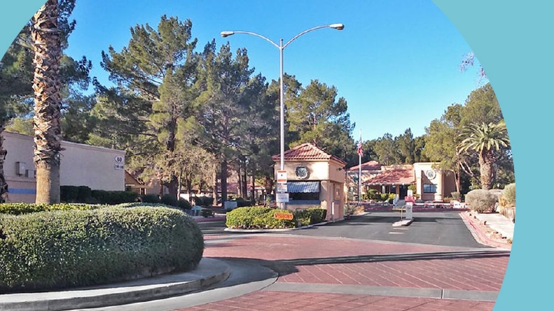 Trees lining the gated entrance to Quail Estates West in Las Vegas, Nevada.