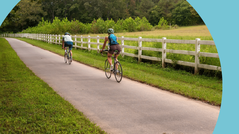 A couple enjoying a Sunday bike ride on the Neuse River Trail in Raleigh, North Carolina.