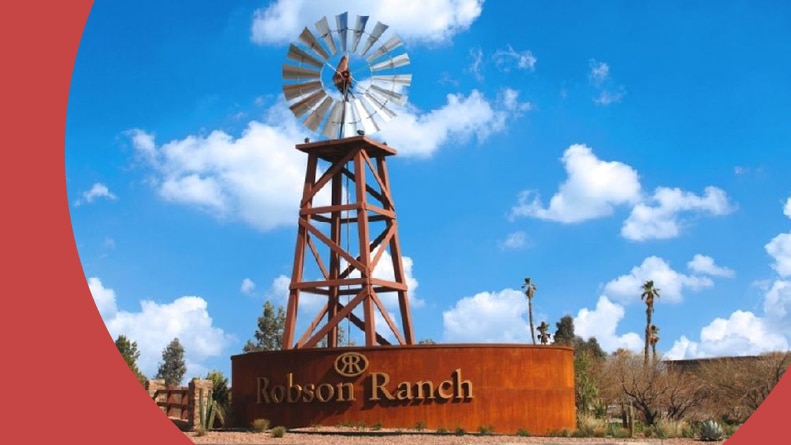 A windmill beside the community sign at Robson Ranch – Arizona in Eloy, Arizona.