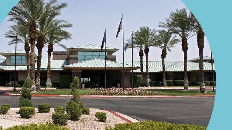 Palm trees beside the clubhouse at the entrance of Sun City MacDonald Ranch in Henderson, Nevada.