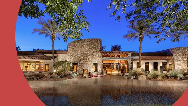 Exterior view of the clubhouse at Trilogy at Vistancia in Peoria, Arizona at night.