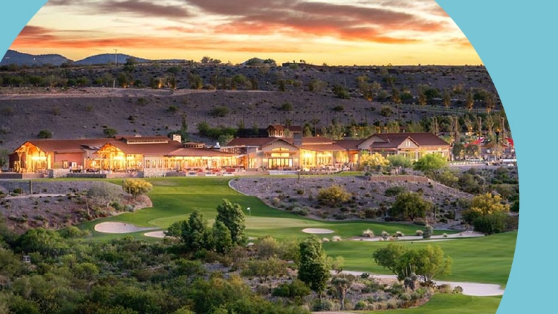 The clubhouse and golf course at sunset at Trilogy at Wickenburg Ranch in Wickenburg, Arizona.
