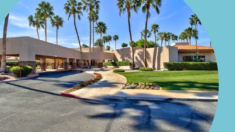 Palm trees surrounding the entrance to Westbrook Village in Peoria, Arizona.
