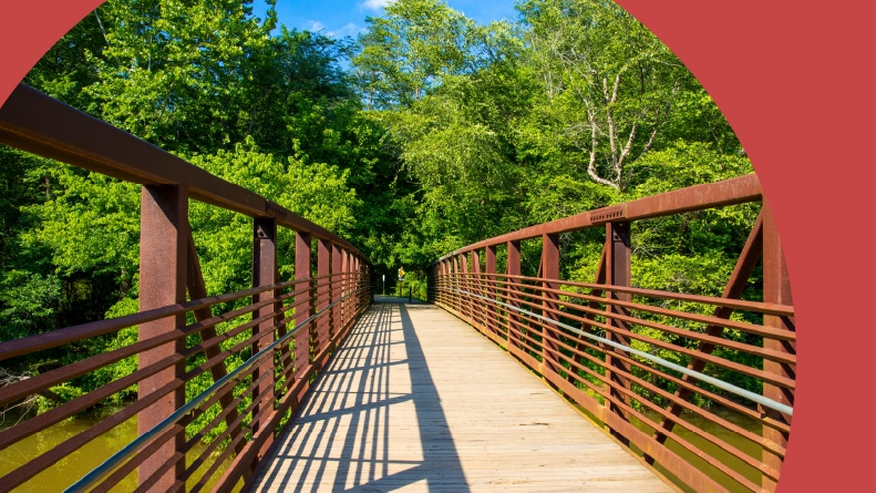 A metal bridge over Little River at Olde Rope Mill Park in Woodstock, Georgia.
