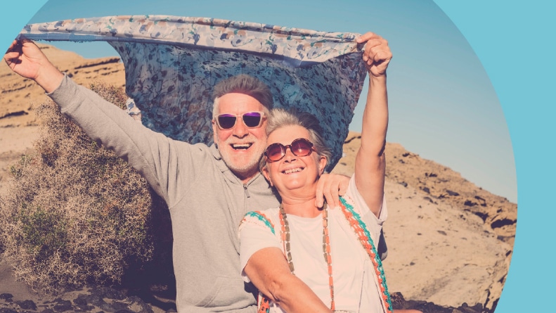 A 55+ couple enjoying some outdoor recreation in a desert environment.