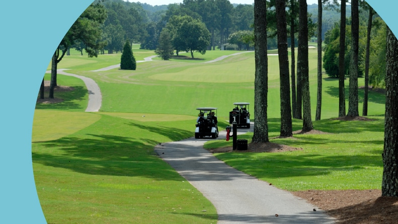 Golf carts on a pathway through a golf course in Athens, Georgia.