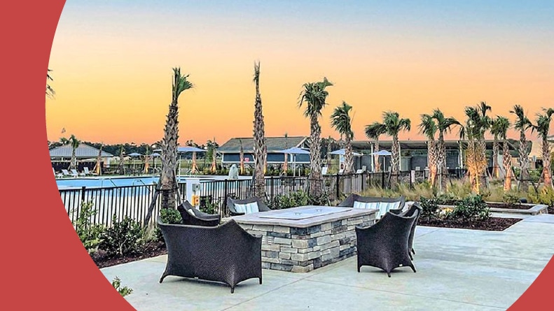 Palm trees, tables, and chairs beside the outdoor pool at Bridgewater in Little River, South Carolina.