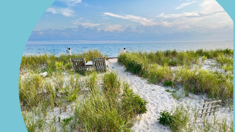 Lounge chairs on the sand along the shore of Cape Cod Bay.