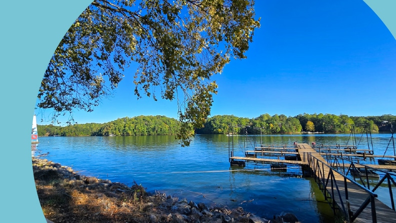 A dock in Lake Lanier Olympic Park with lush green trees in Gainesville, Georgia.