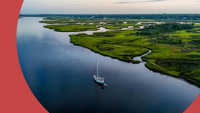 Aerial view of a boat sailing through the intercostal waterways beside marshland near Jacksonville, Florida.